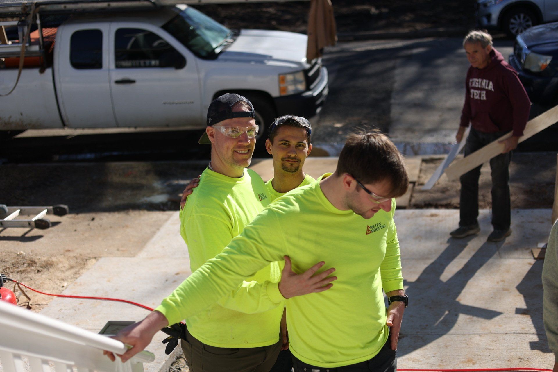 Image of RETEX's Mark Erickson, Caleb Kammerling, and Josh Lewis goofing off at Richmond Habitat for Humanity job site.
