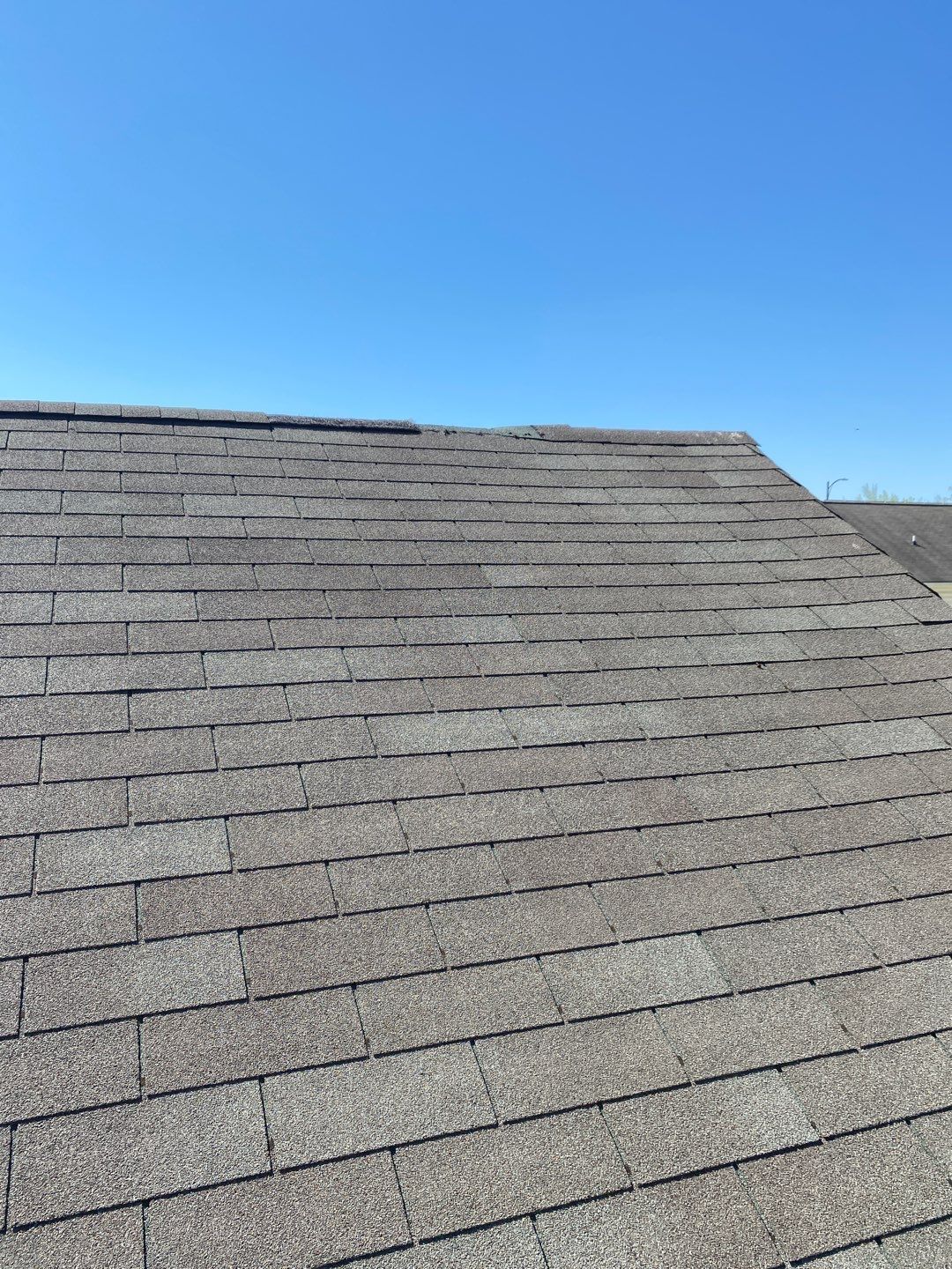 Image of damaged ridge cap on Richmond VA home.