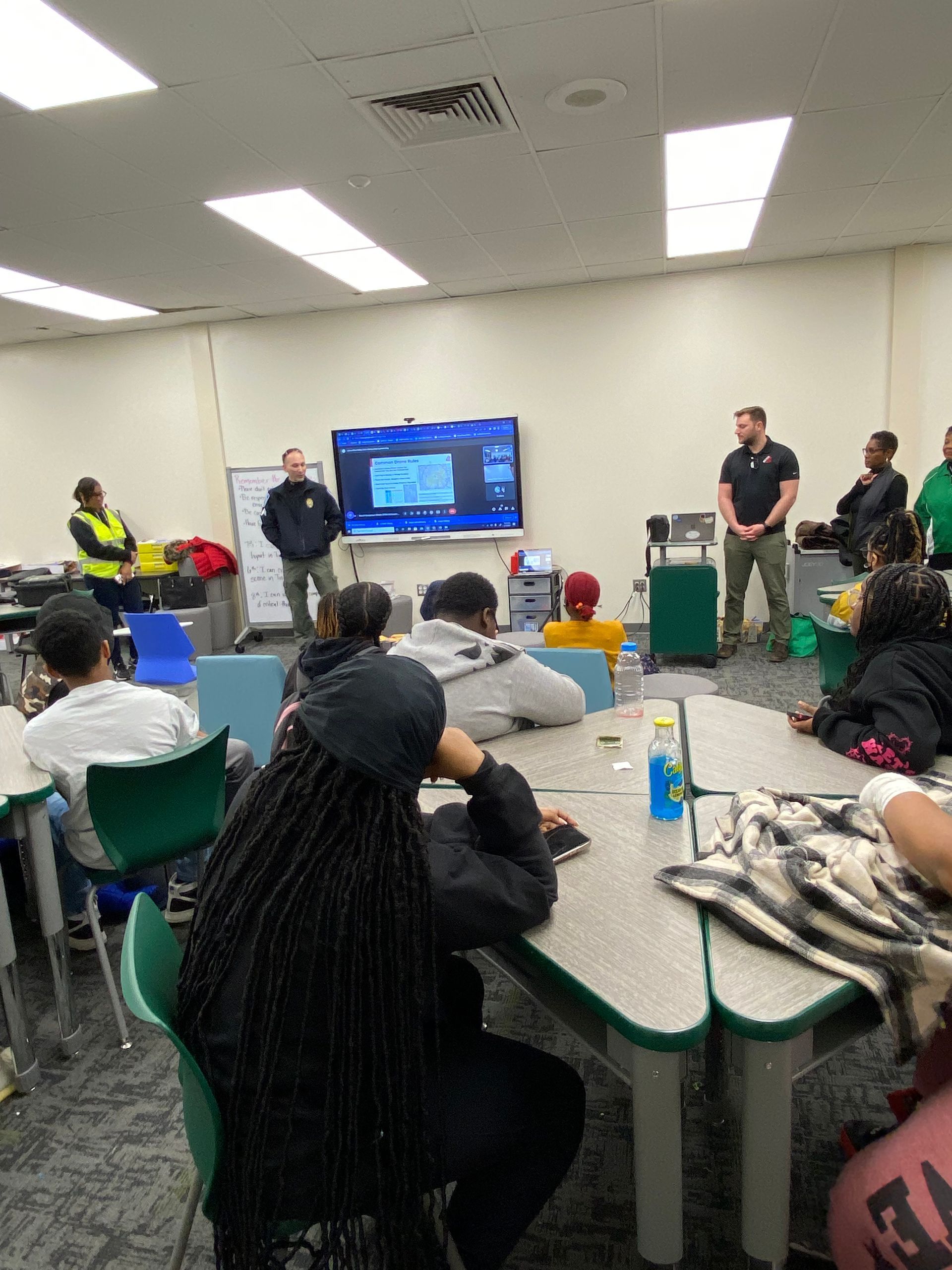 Image of RETEX's Josh Lewis teaching local 7th graders how to fly a drone.
