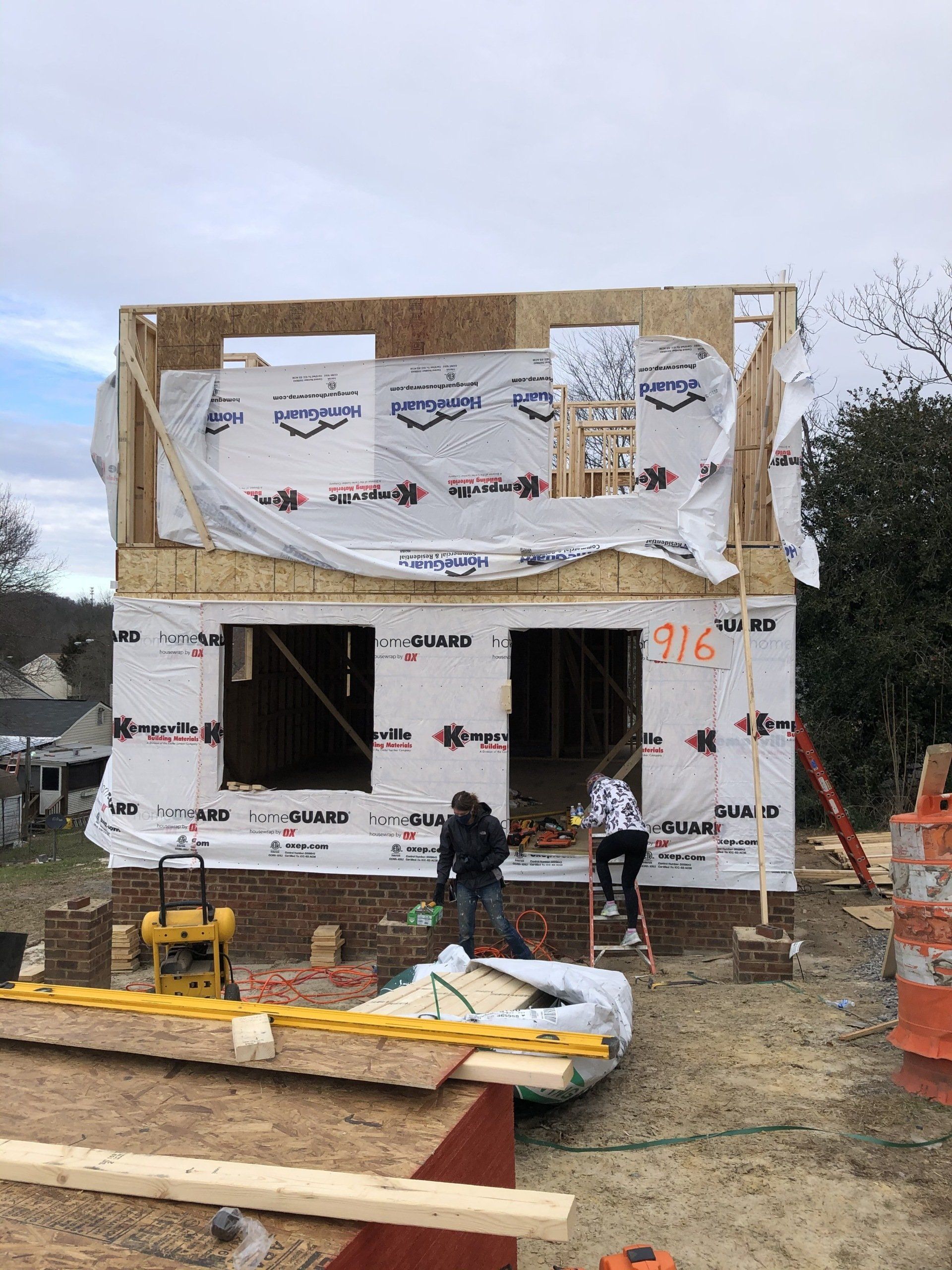 Image of RETEX's Katelyn Lewis entering a Richmond Habitat for Humanity build site during a volunteer day.