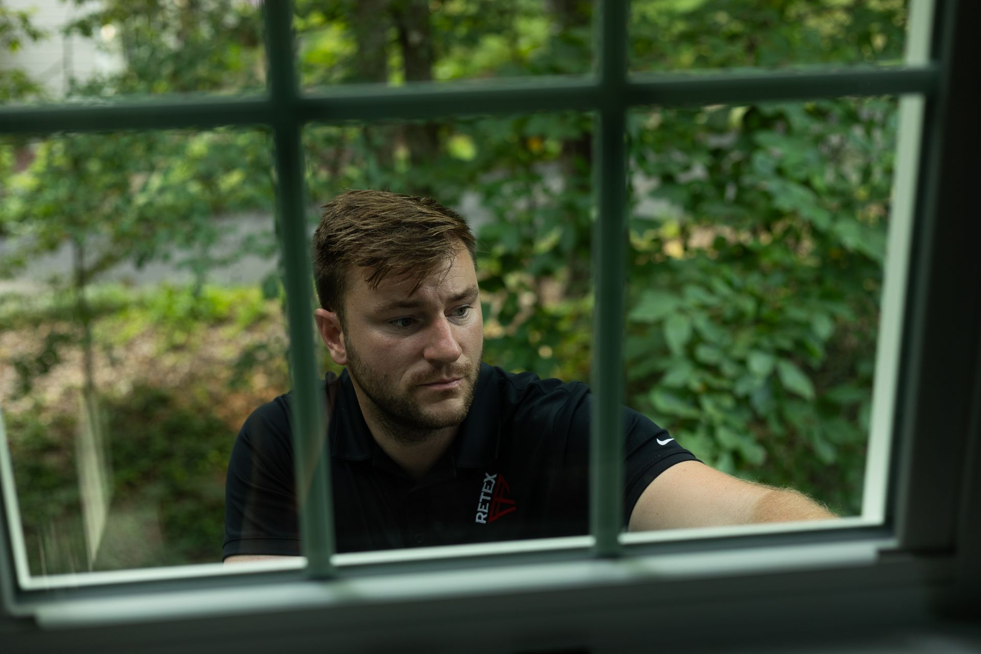 Image of RETEX's Josh Lewis inspects a newly-installed Provia triple-pane window in North Chesterfield, VA in September 2023.