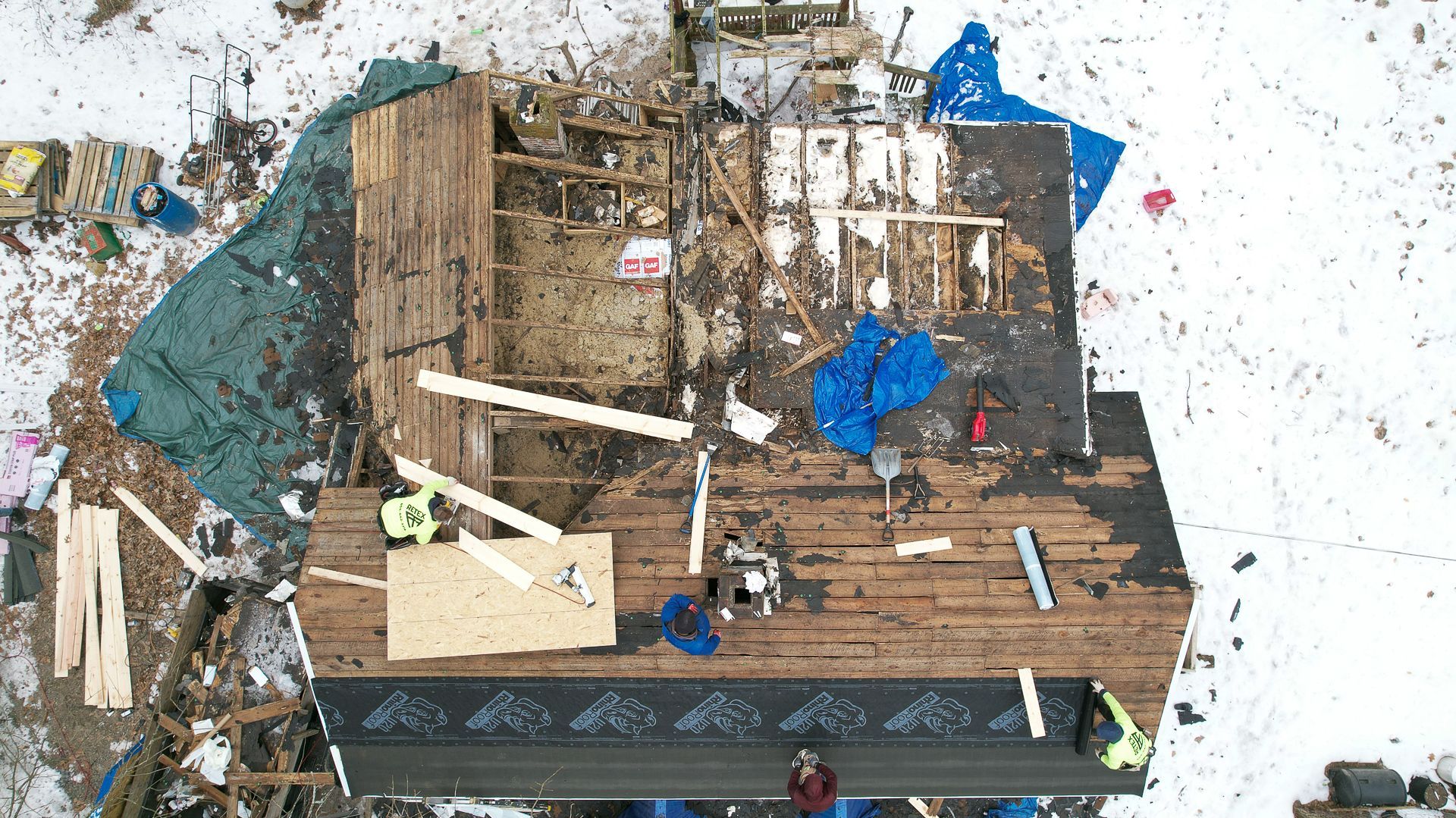 RETEX crew members strip a roof down for its replacement in Spotsylvania, VA on Jan. 21, 2025.