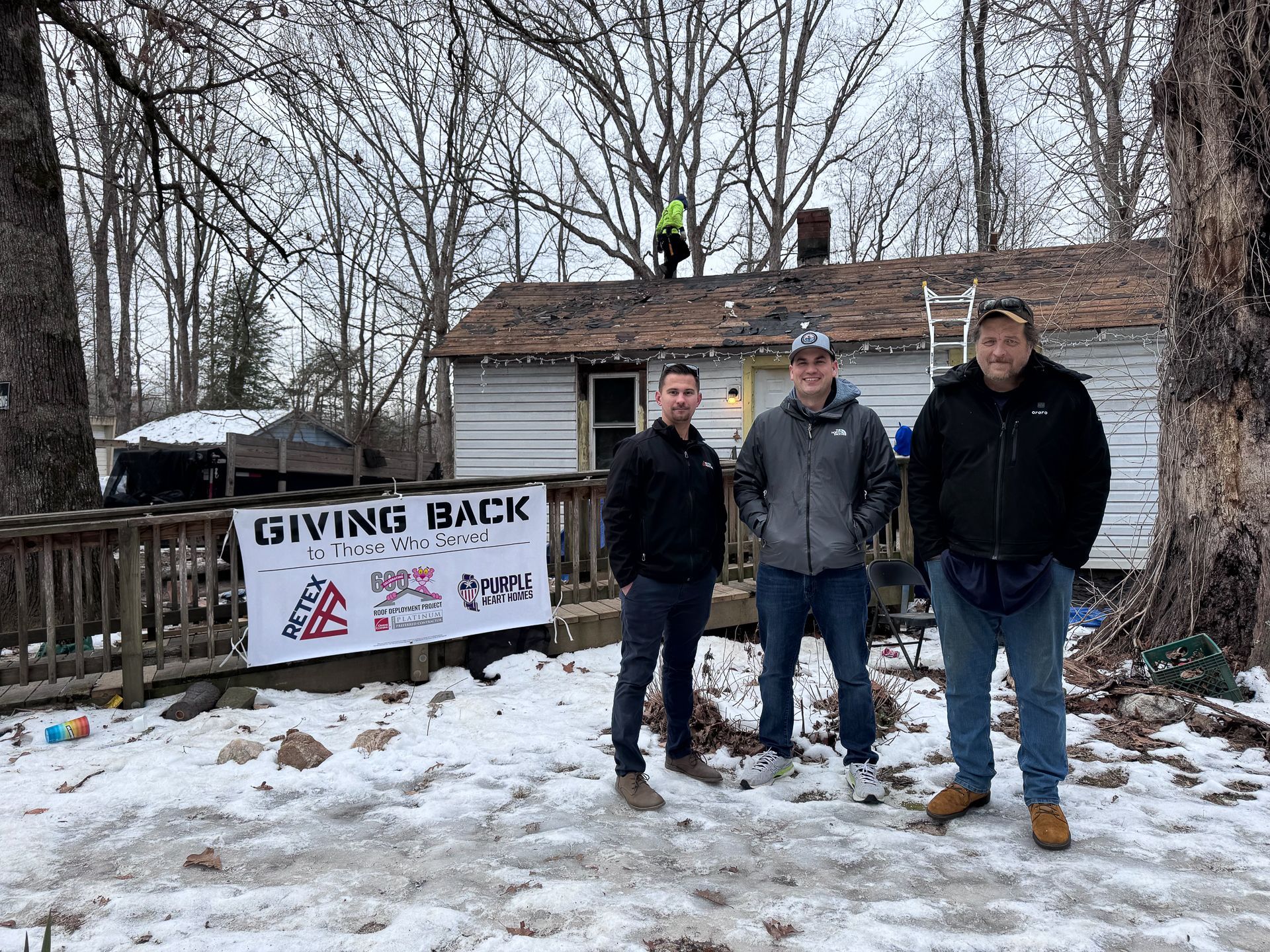 RETEX's Caleb Kammerling, Owens Corning's Trey Smith, and Matthew Carver – son of Daniel Carver – stand in front of the home where RETEX installed a new roof on Jan. 21, 2025, for a local veteran at no charge.