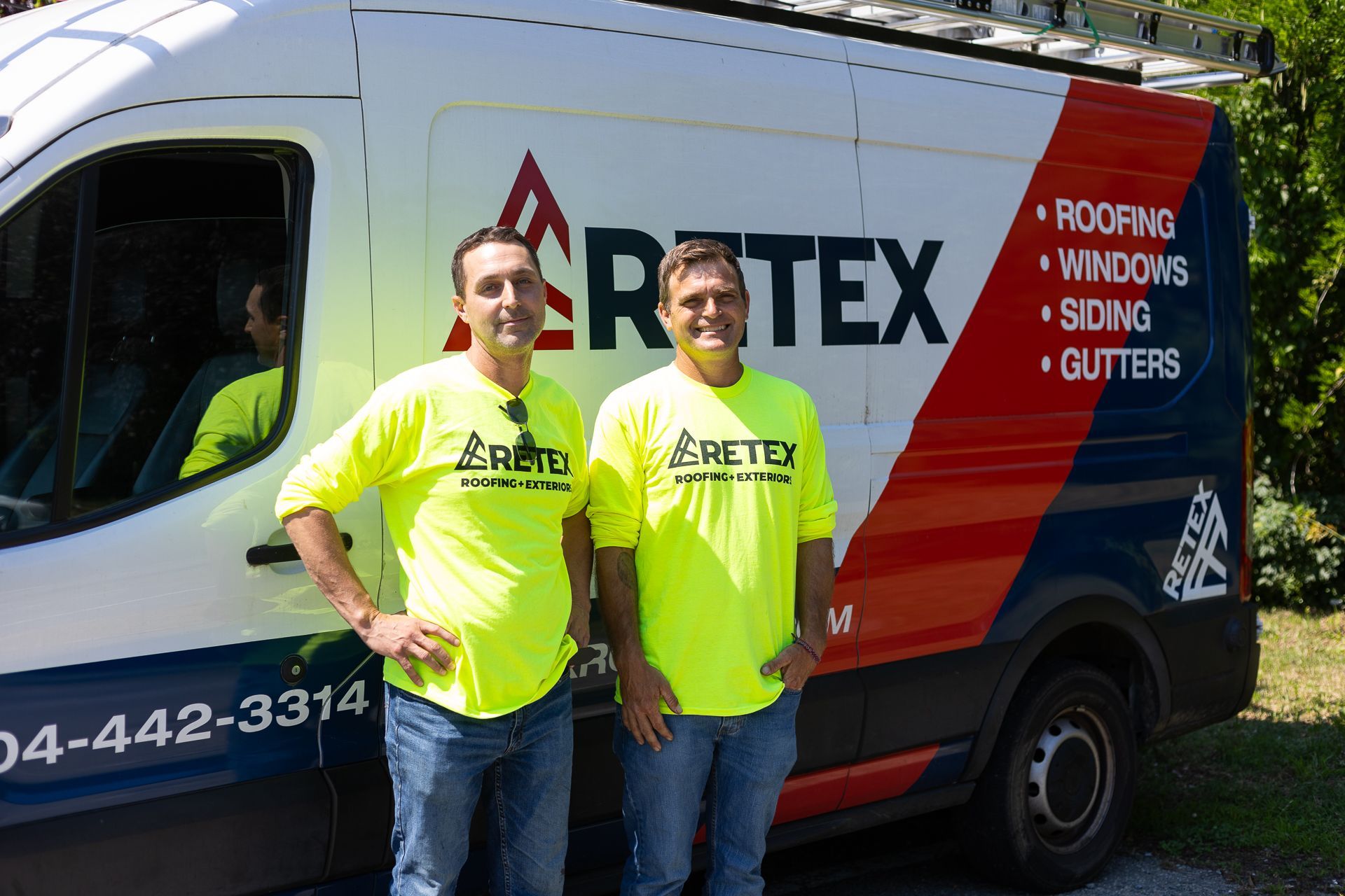 Repair Team Bravo (Scott Gibson and Patrick Nelson) stand in front of a RETEX Repair van. 