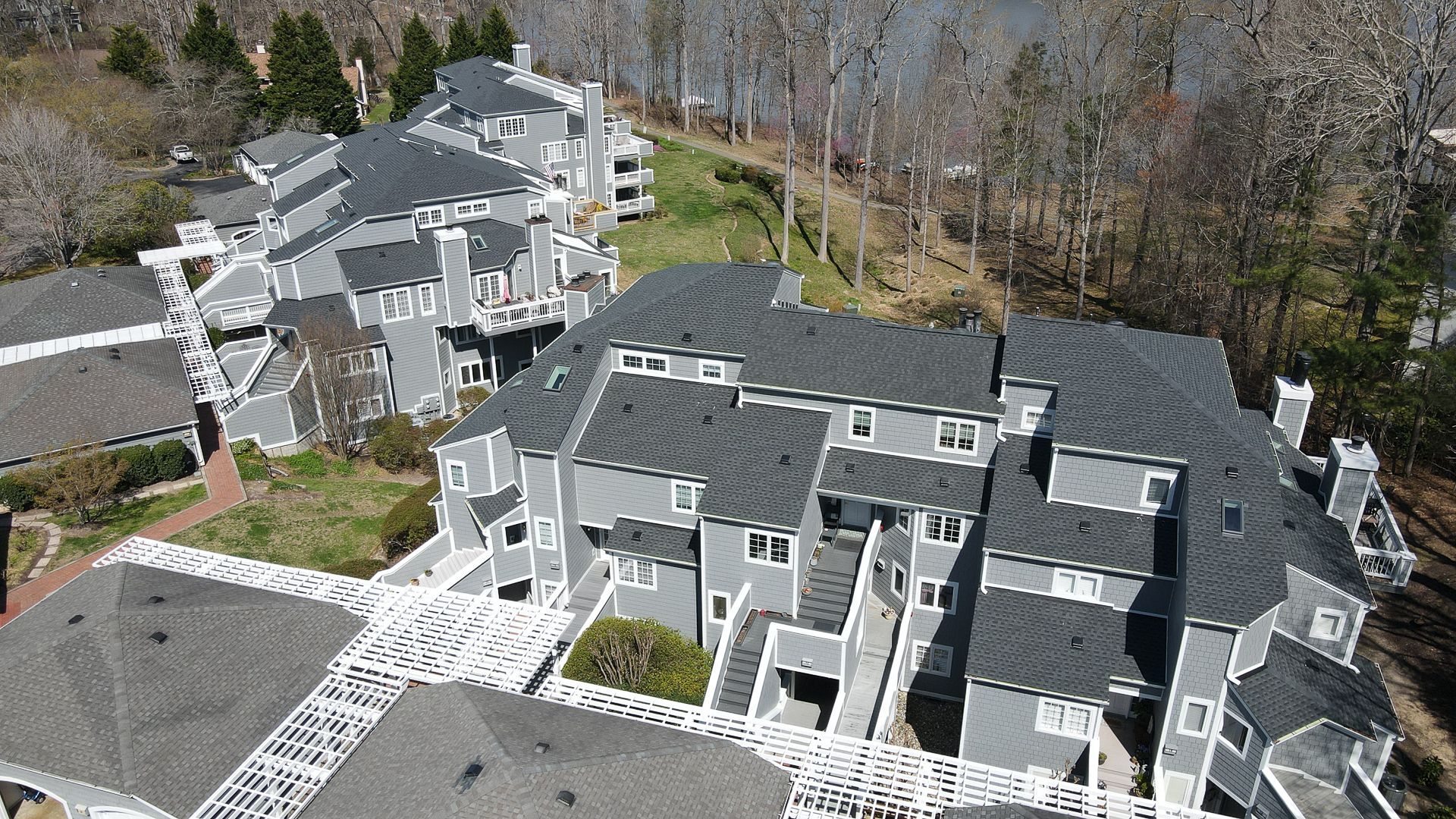 Aerial photo of Spinnaker Cove condos. RETEX replaced the shingle roofs, flat roofs, and siding.