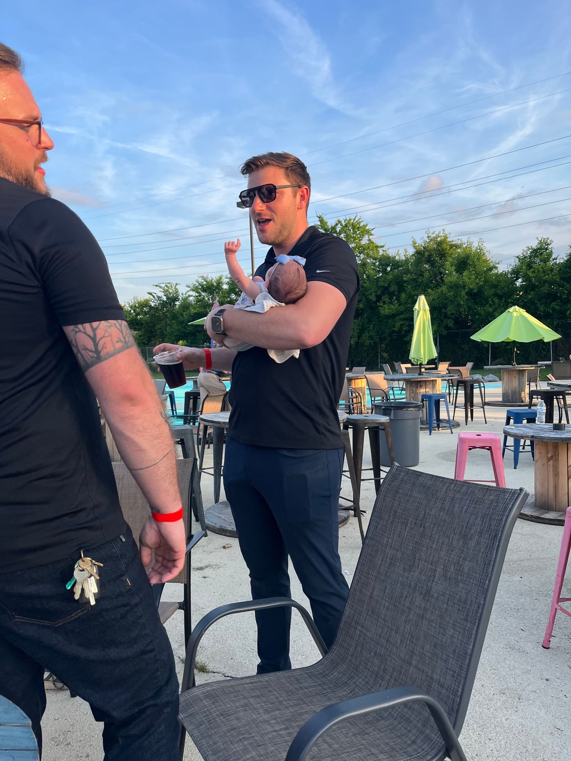 Image of RETEX's Josh Lewis holding RETEX's Andy Connor's baby daughter from our June Client Appreciation event in 2023.