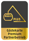A gold and black logo that says gästekarte premium partnerbetrieb