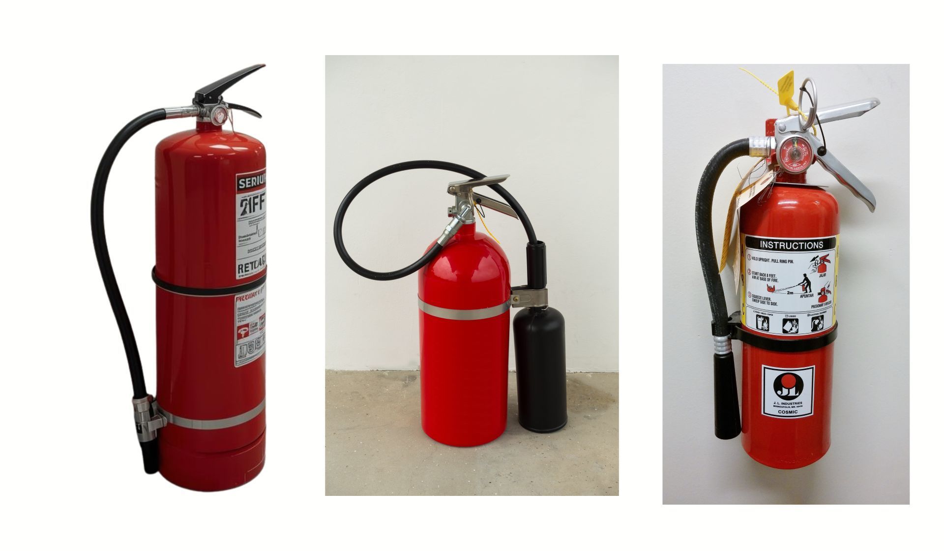 Three red fire extinguishers with black hoses, mounted and free-standing.
