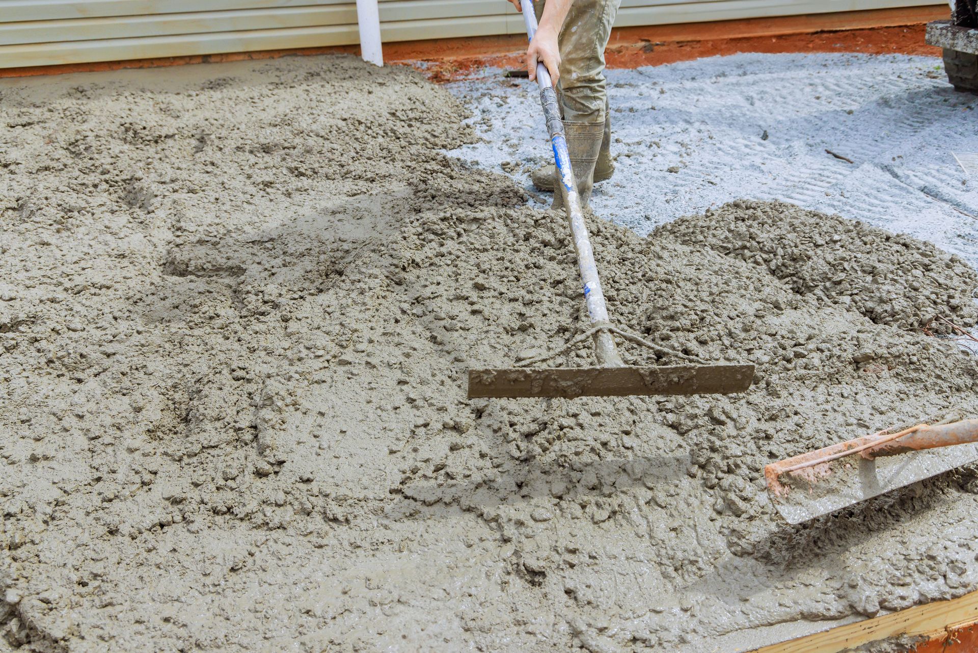 spreading fresh concrete on residential job