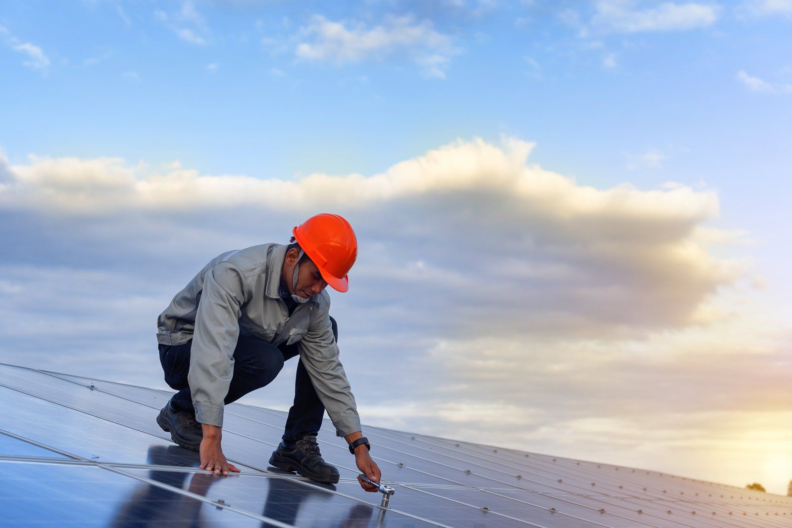 worker checking the solar panels
