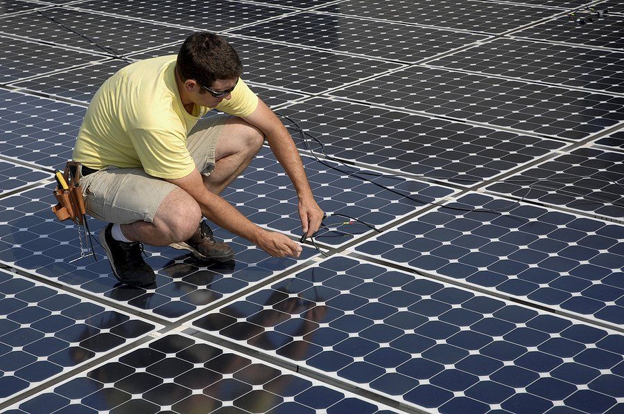 worker stepping in the solar panel