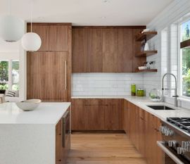 A kitchen with wooden cabinets and white counter tops