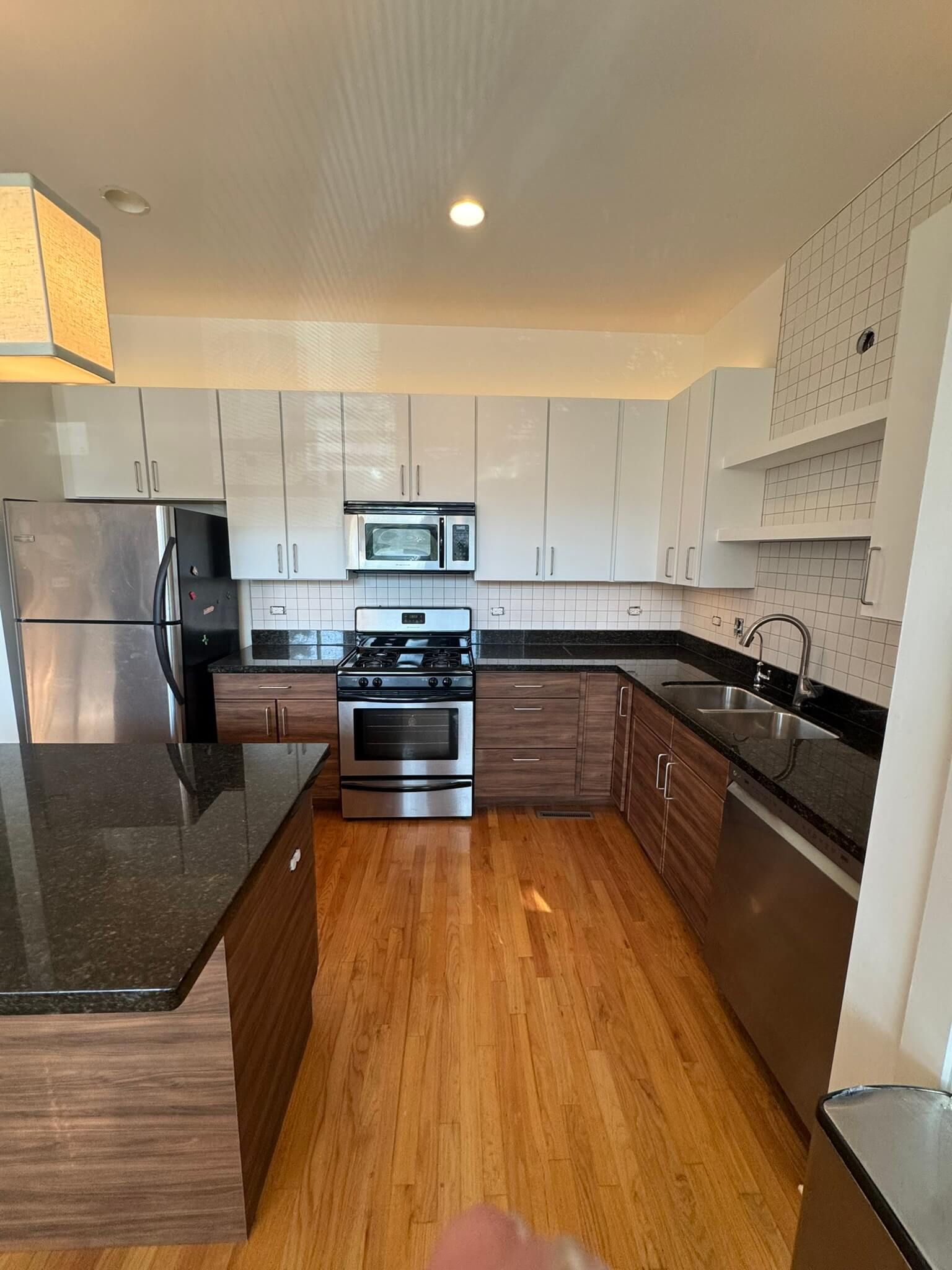 A kitchen with white cabinets and stainless steel appliances.