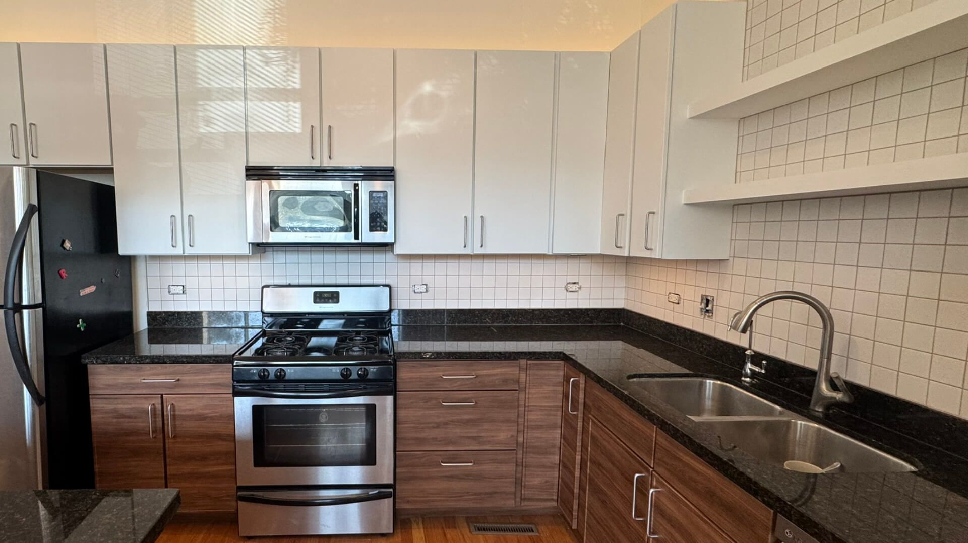 A kitchen with white cabinets and stainless steel appliances.