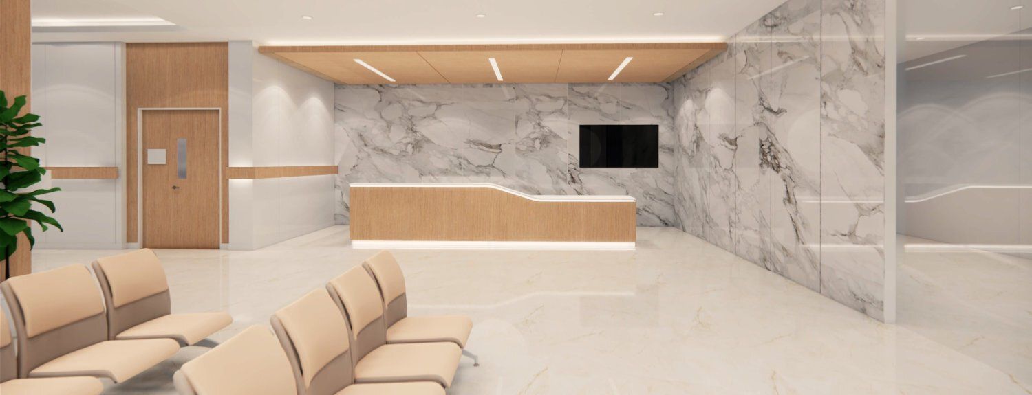 A waiting room in a hospital with chairs and a counter.