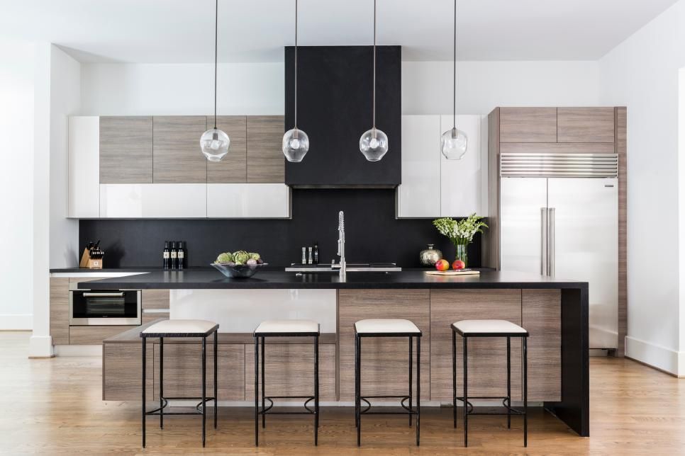 A kitchen with a large island and stools