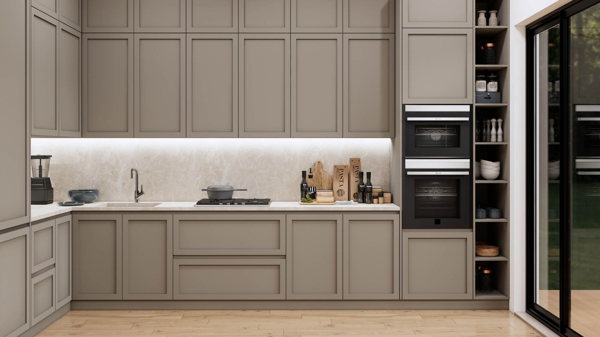 A kitchen with gray cabinets , a sink , an oven , and a sliding glass door.