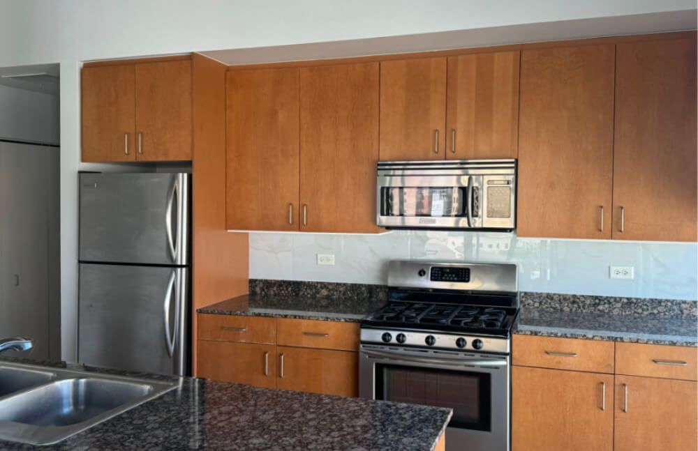 A kitchen with stainless steel appliances and wooden cabinets