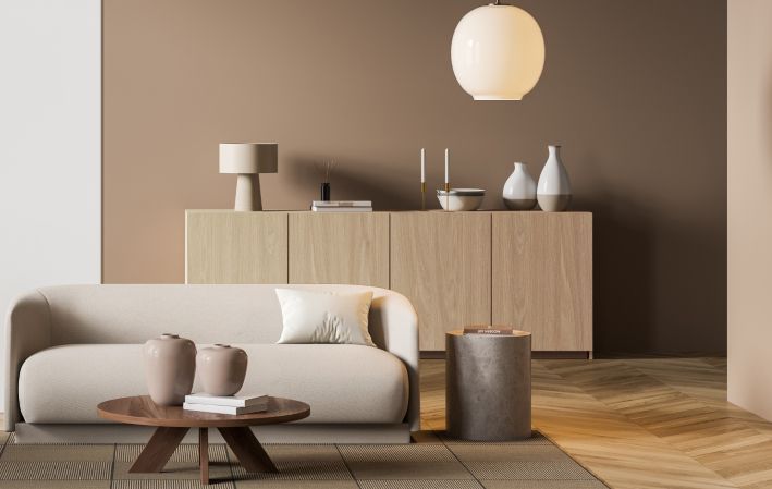 A living room with a couch , table , and vases.
