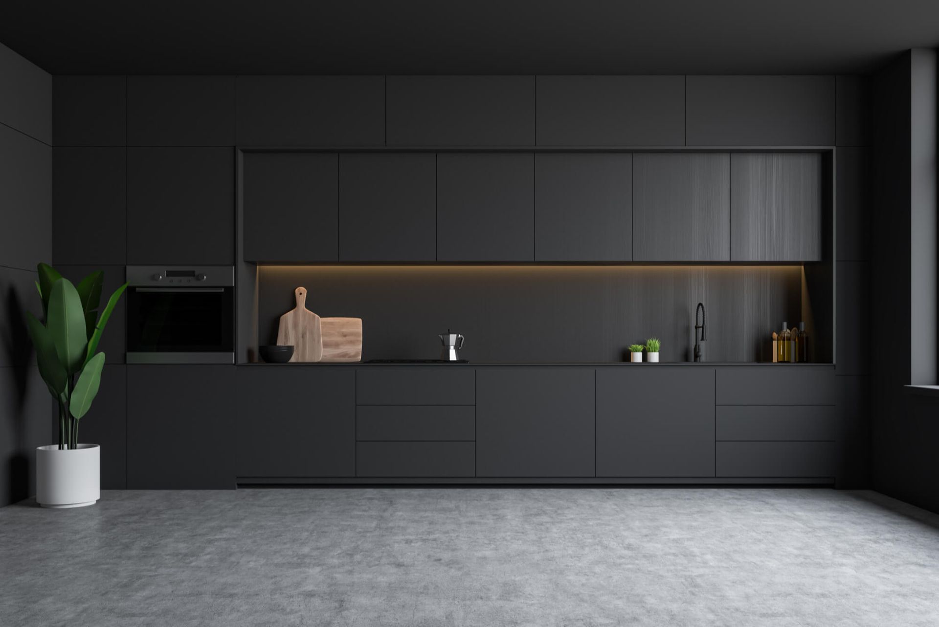 A modern kitchen with black cabinets and a concrete floor.