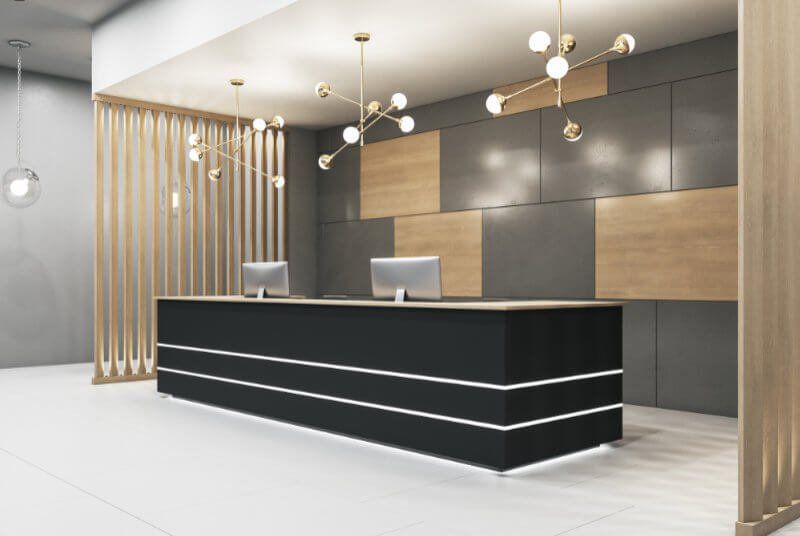 There is a long black counter in the middle of the room.