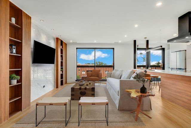 A living room with a white couch and a flat screen tv