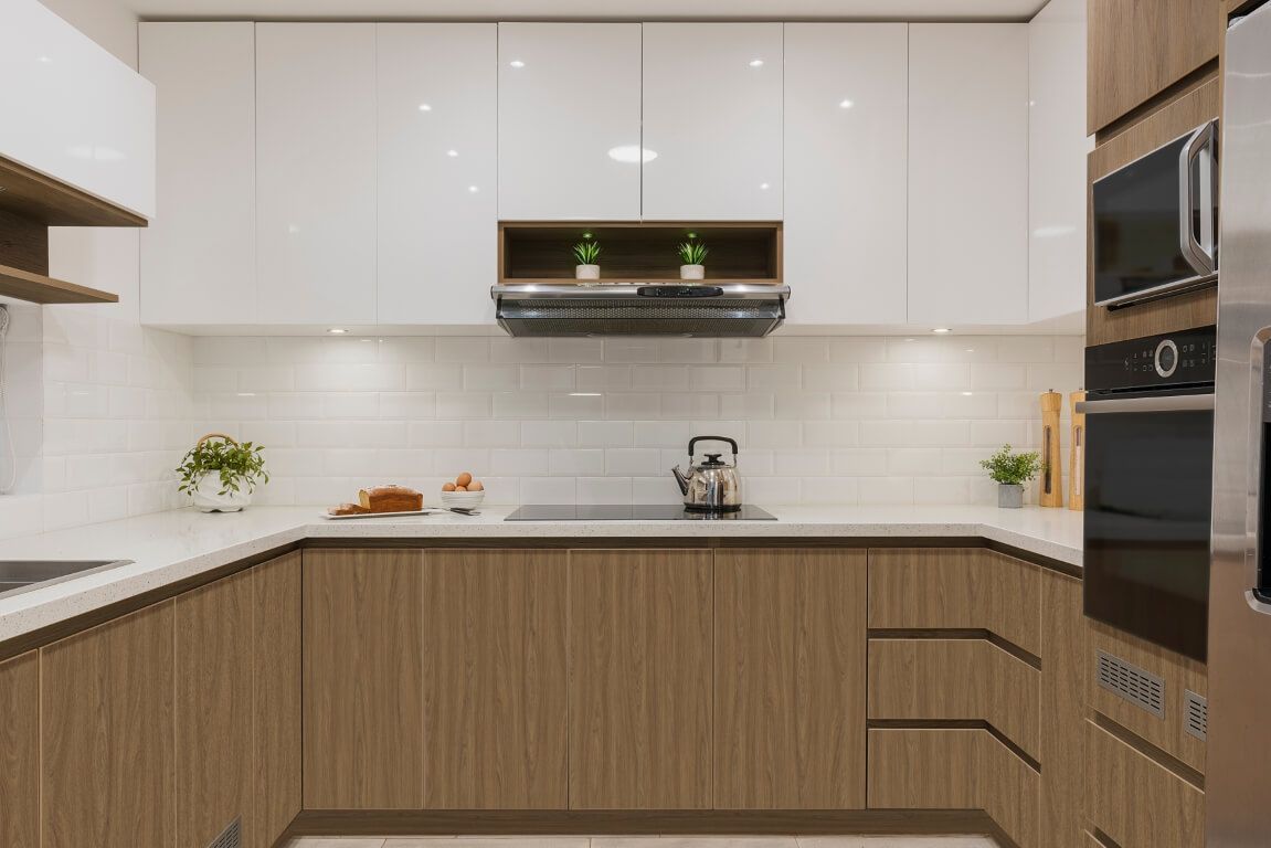 A kitchen with wooden cabinets and white cabinets and a stove top oven.