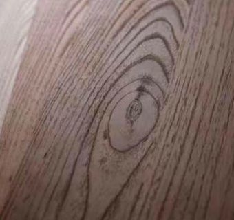 A close up of a piece of wood with a drawing of an eye on it.