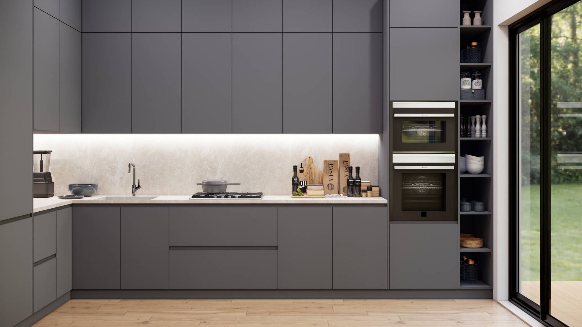 A kitchen with gray cabinets , a sink , an oven , and a sliding glass door.