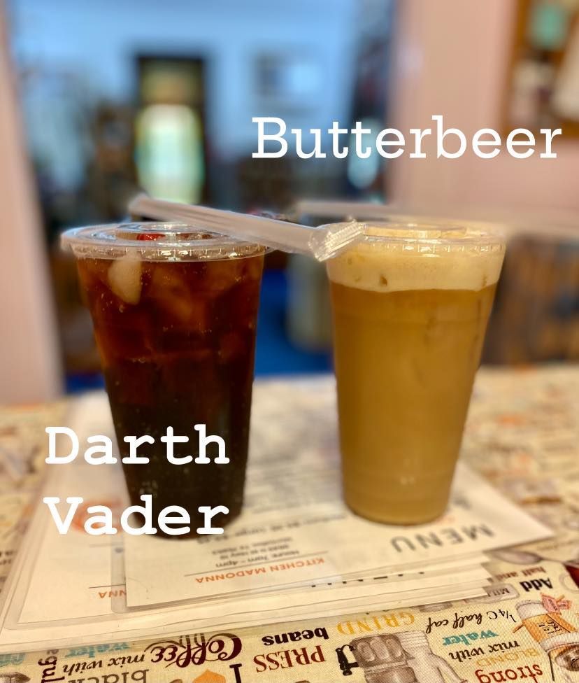 Two cups of butterbeer and darth vader are on a table