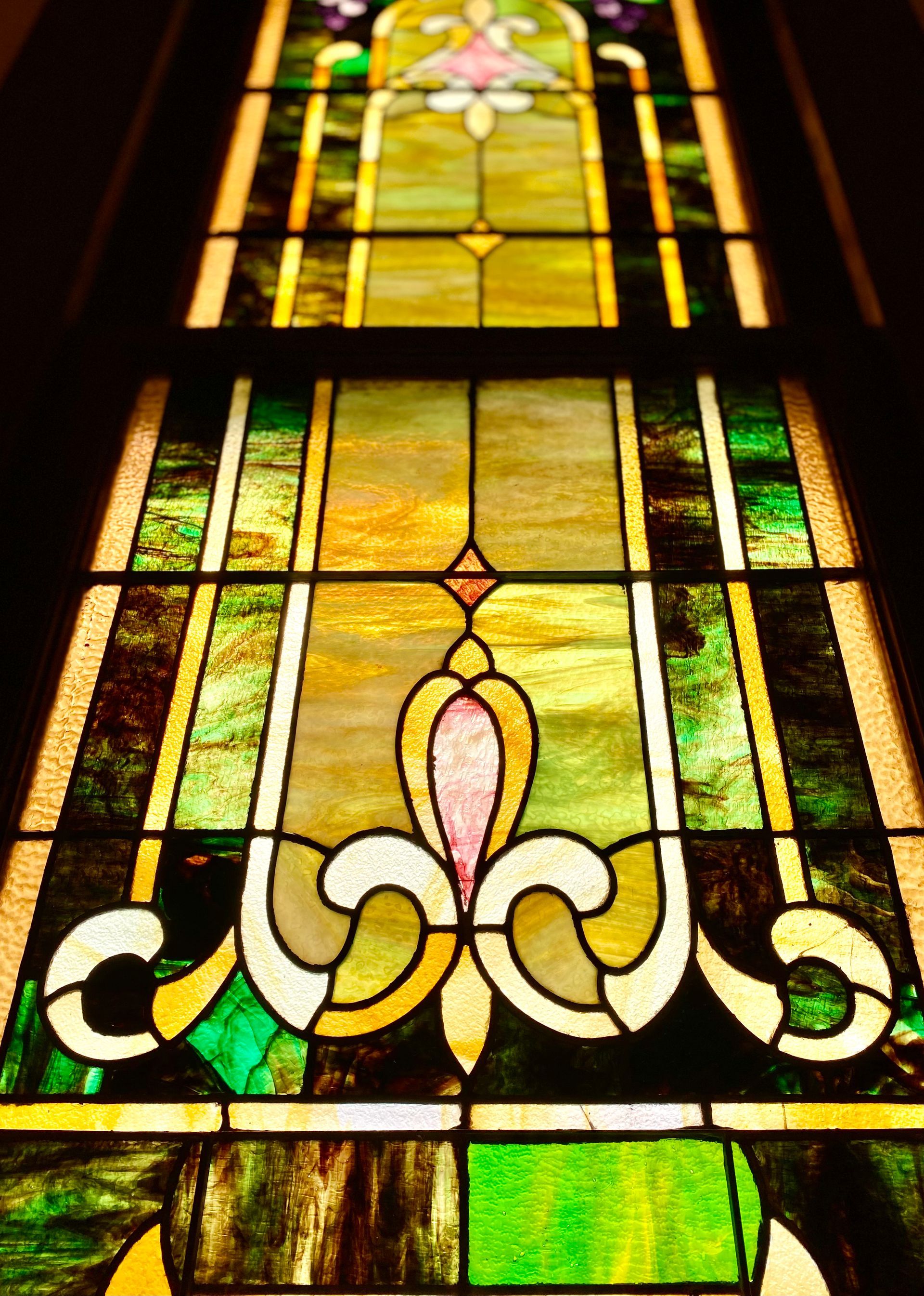 A table with a statue of a woman surrounded by books and flowers