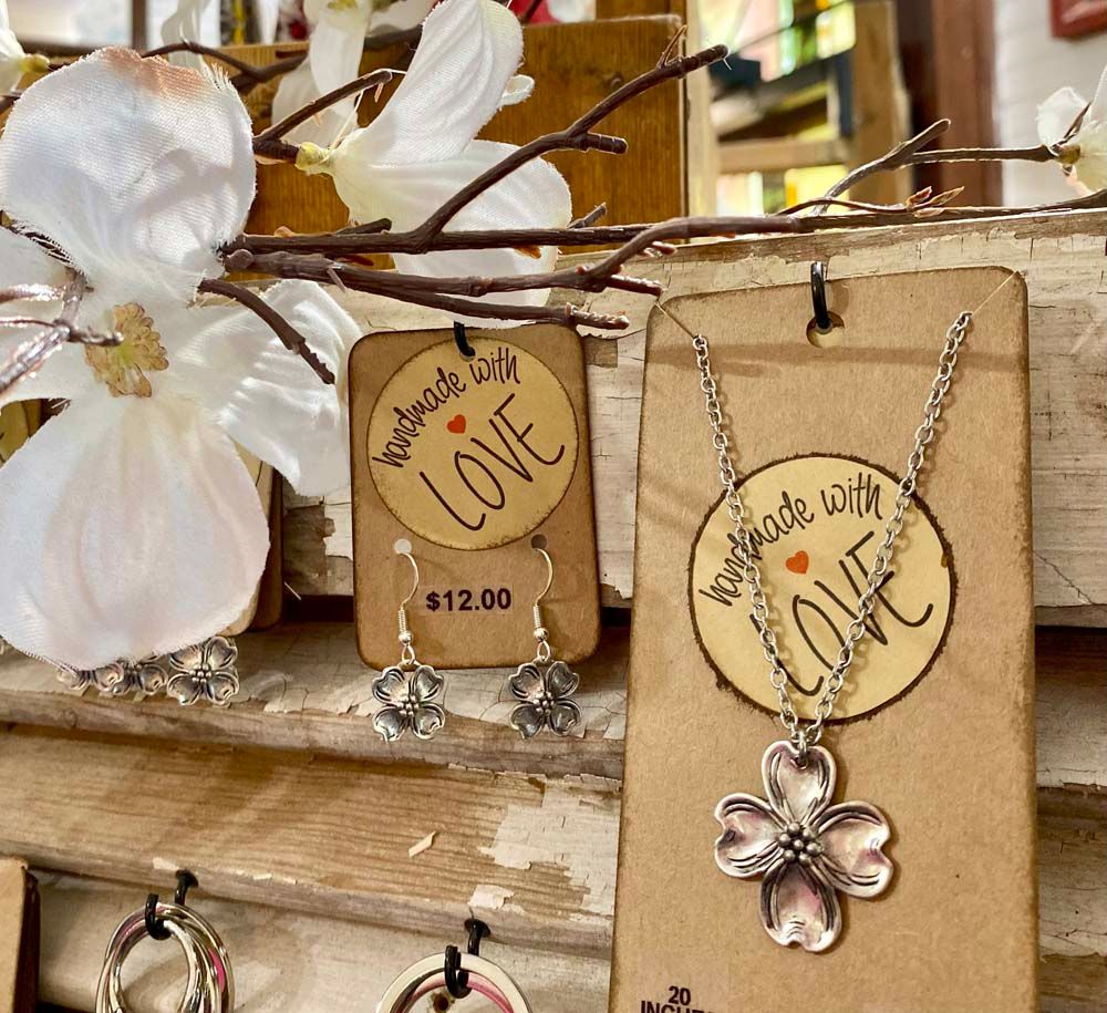 A pair of handmade with love earrings and a necklace