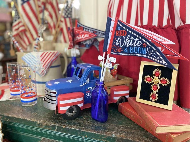 A red white and blue truck is sitting on top of a table.