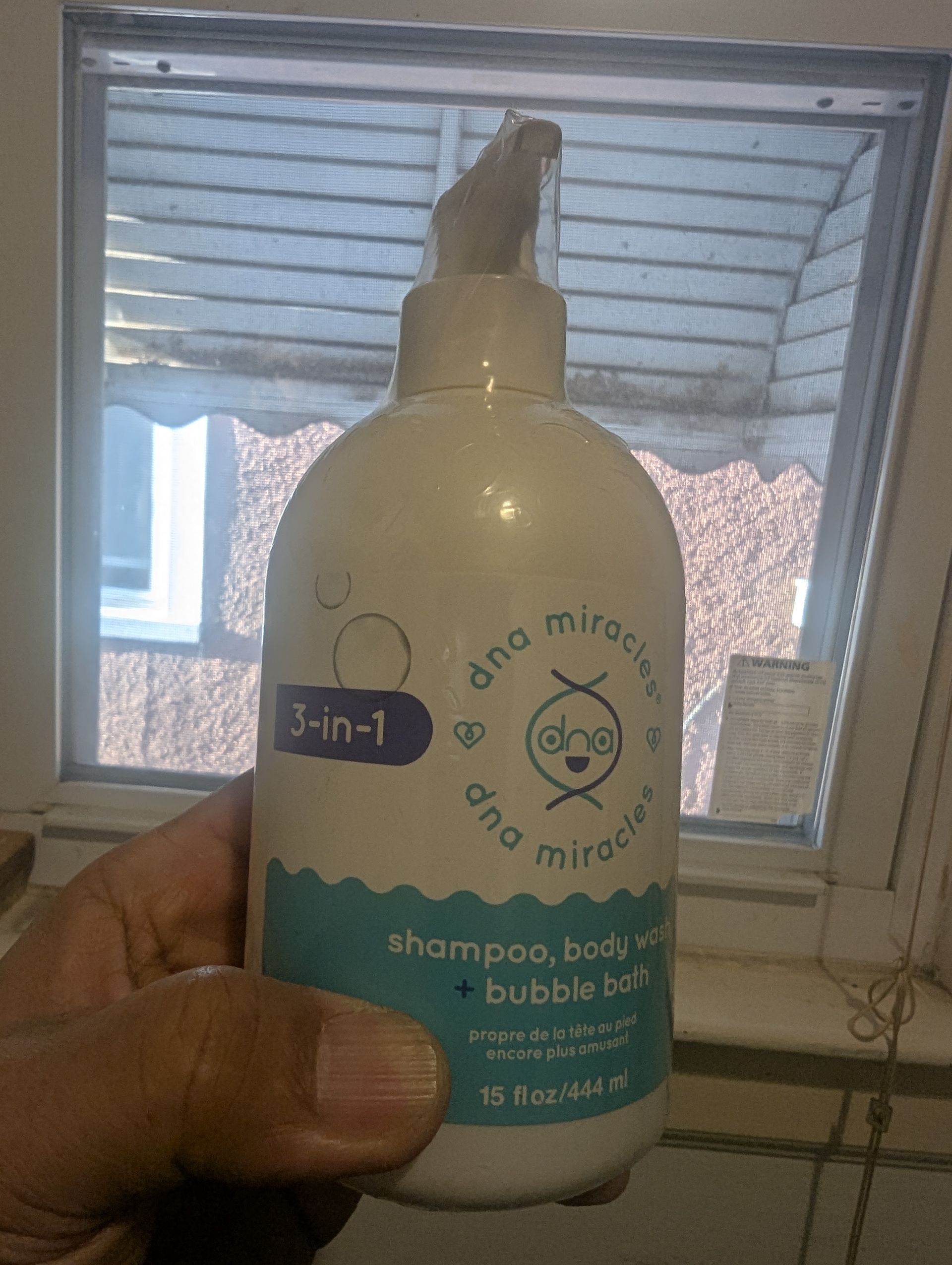 Hand holding a bottle of