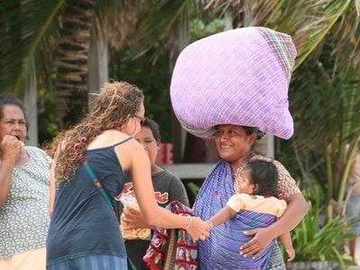 Missionary woman interacting with a local woman and her child