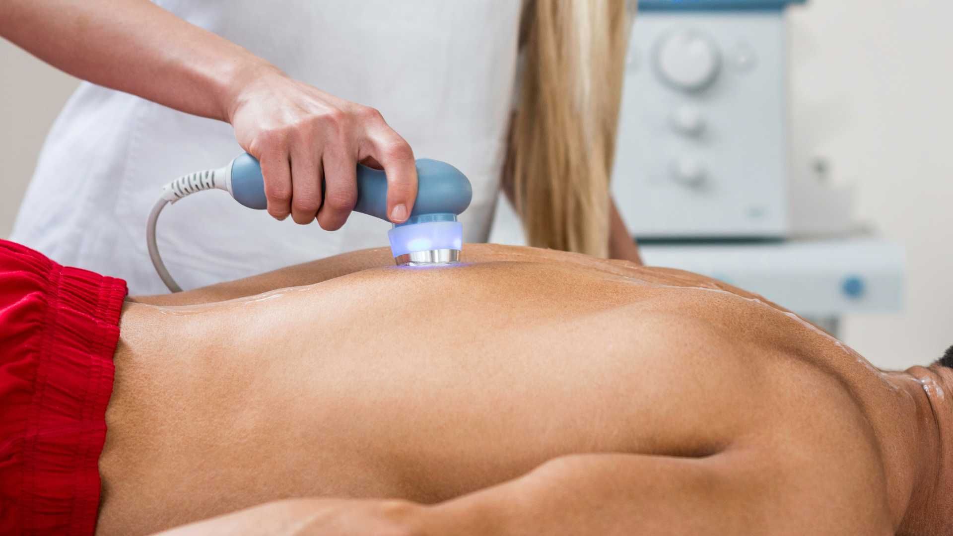 a man is getting an ultrasound treatment on his back .