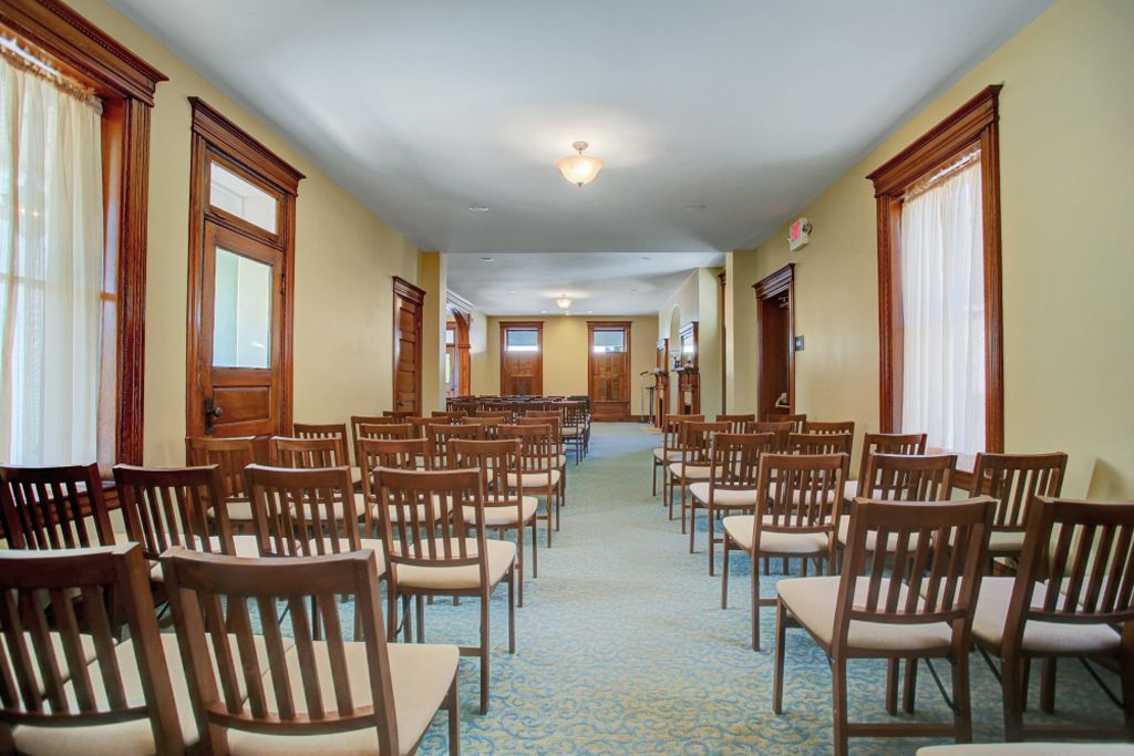 Rows of chairs are lined up in an empty room