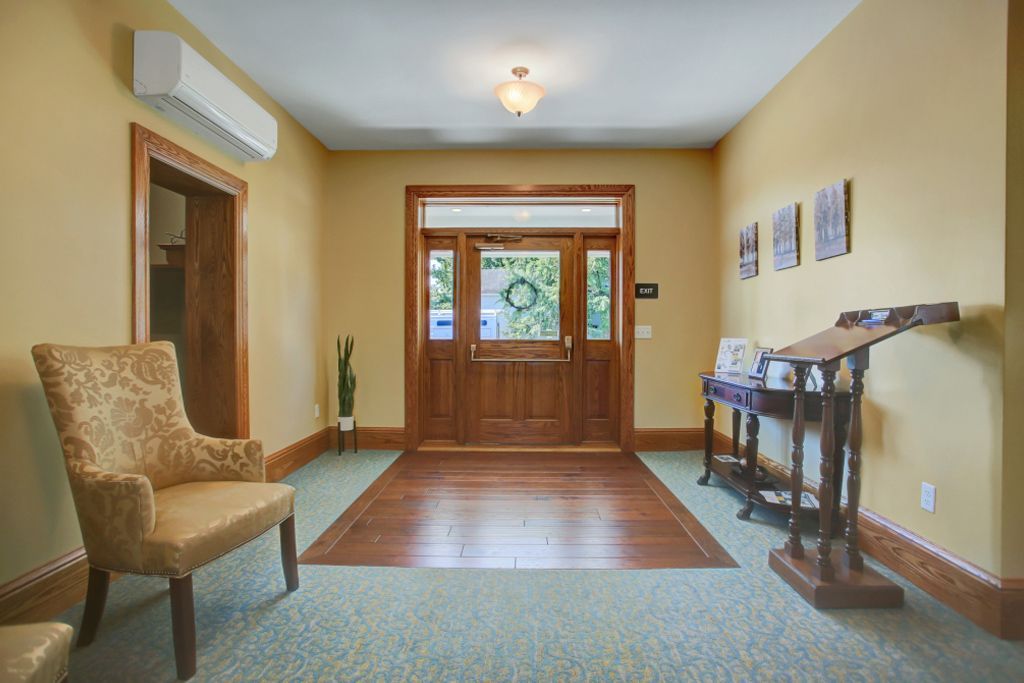 There is a chair in the middle of the hallway.