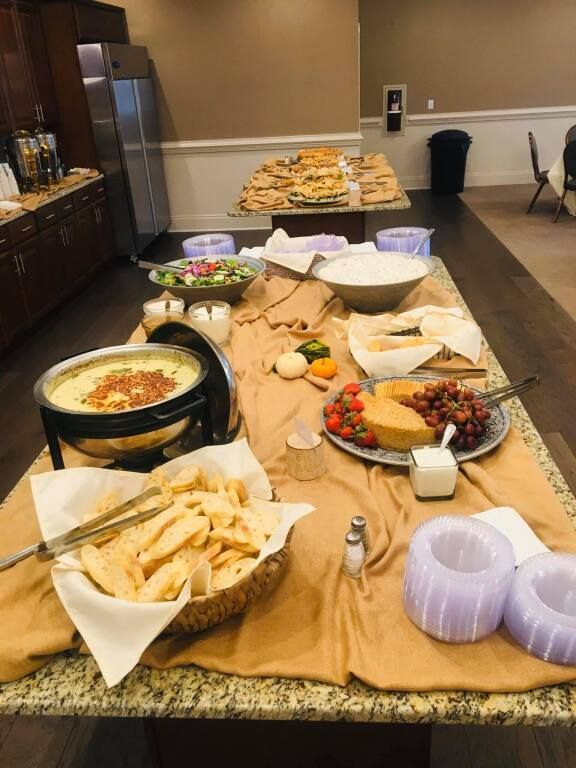 A buffet table with a variety of food on it.