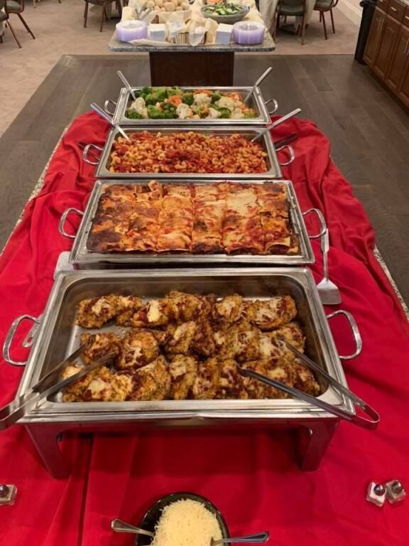A buffet table with a variety of food on it.