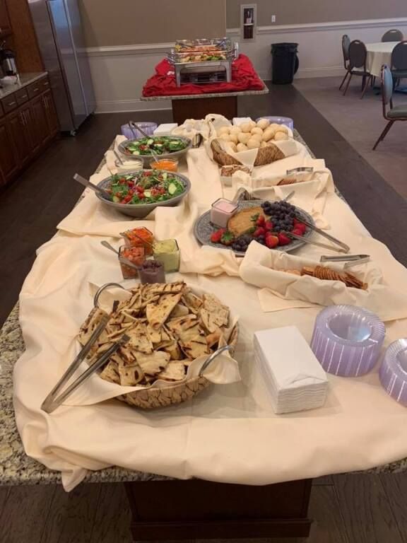 A buffet table with a variety of food on it