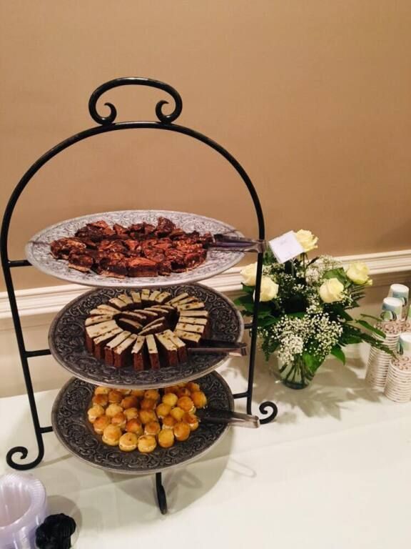 Three plates of food are on a tray on a table