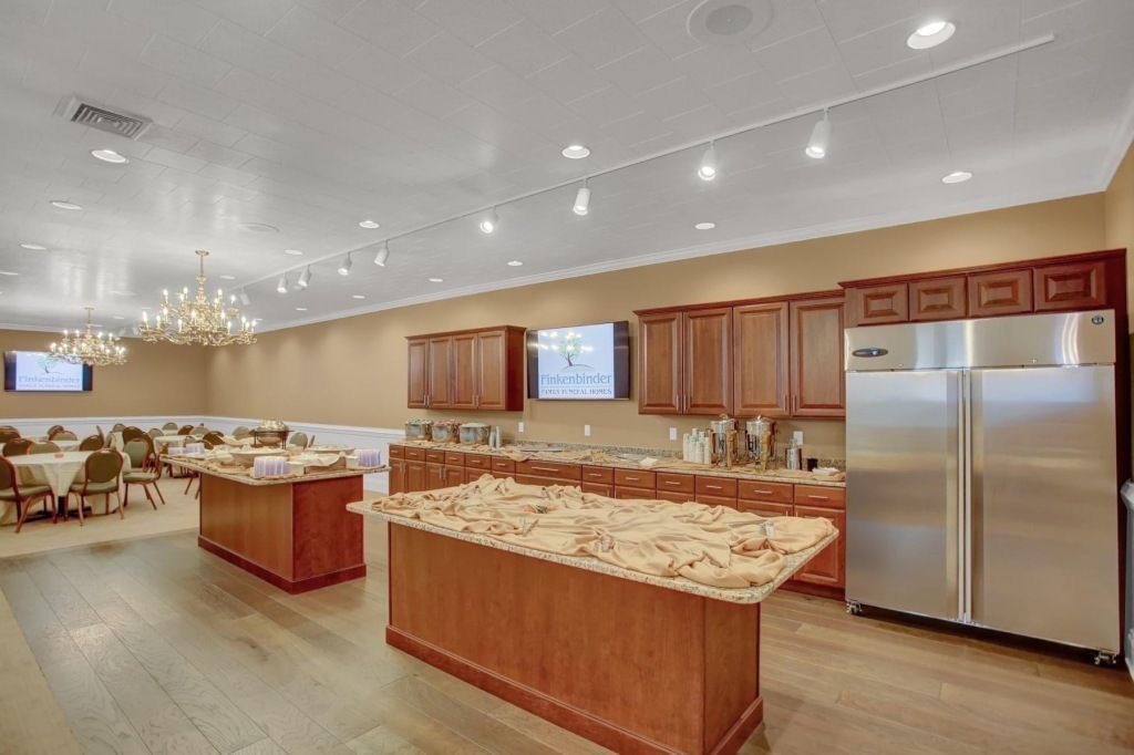 A large kitchen with stainless steel appliances and wooden cabinets.