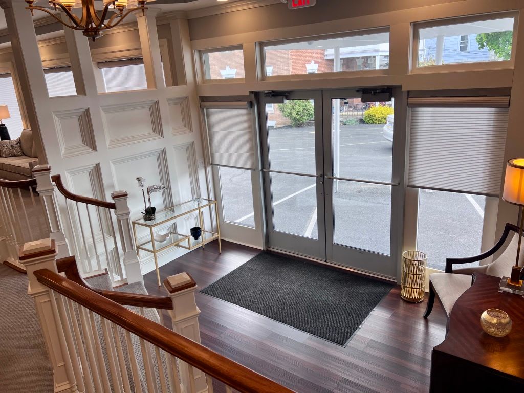 An aerial view of a living room with a staircase leading to a doorway.