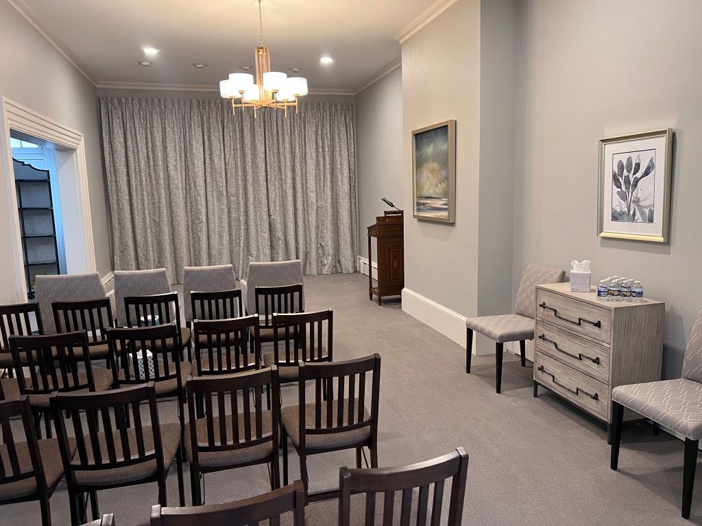 A room with rows of chairs and a podium in it.