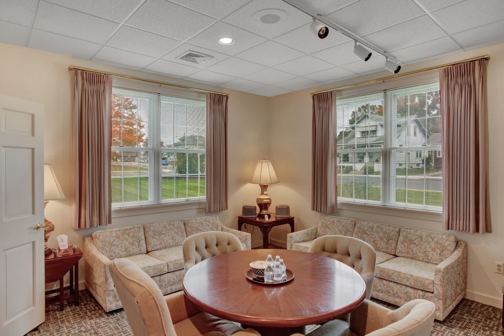 A living room with a round table and chairs