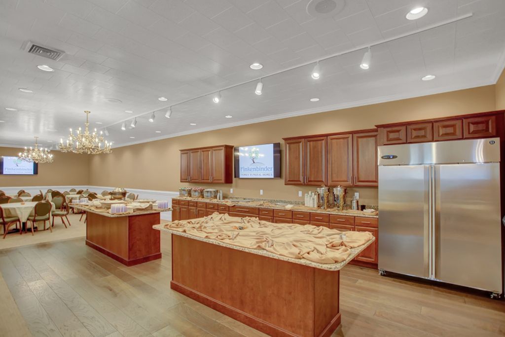 A large kitchen with stainless steel appliances and wooden cabinets.