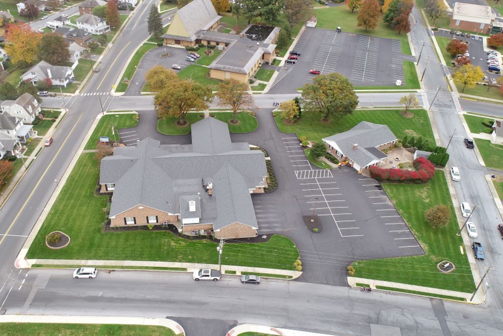 An aerial view of a residential area with a large building in the middle