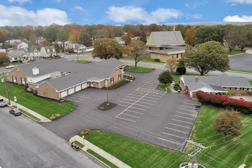 An aerial view of a residential area with houses and a parking lot.