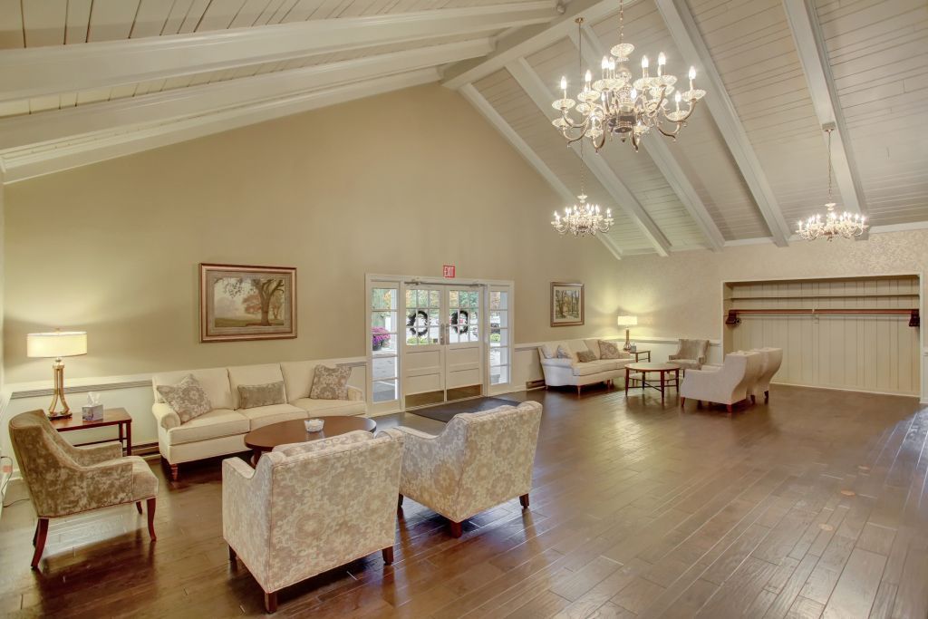A large living room filled with furniture and a chandelier.